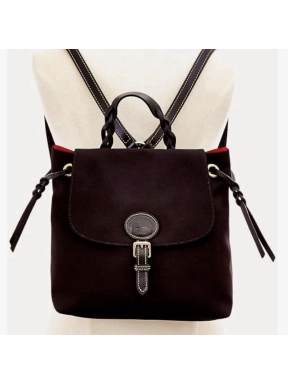 Dooney & Bourke Nylon Flap Backpack features a distinct braided top handle š¹